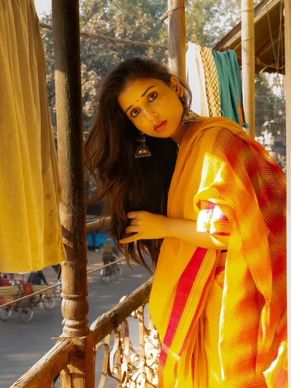 Looking out from a balcony, with the busy street below blurred out. This creates a sense of being in a private oasis above the city.
