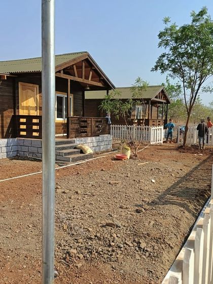 The farmhouse project in progress. The ground is ready, and my team is beginning to shape the landscape around the newly built cabins.