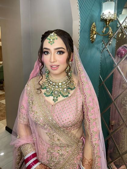 The makeup is soft and glowing, enhancing her natural beauty.