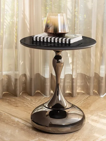 Our Onyx Elegance side table is a customer favorite for a reason. The sculptural base has a stunning gunmetal finish, and the black marble top adds a layer of sophisticated drama. It’s a compact piece that delivers a big impact, perfect next to a sofa or your favorite armchair.