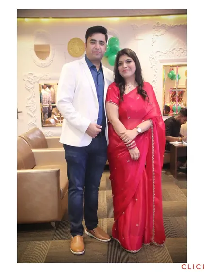 A well-dressed couple posing for a portrait at a family function. We also take great photos of couples during family events.