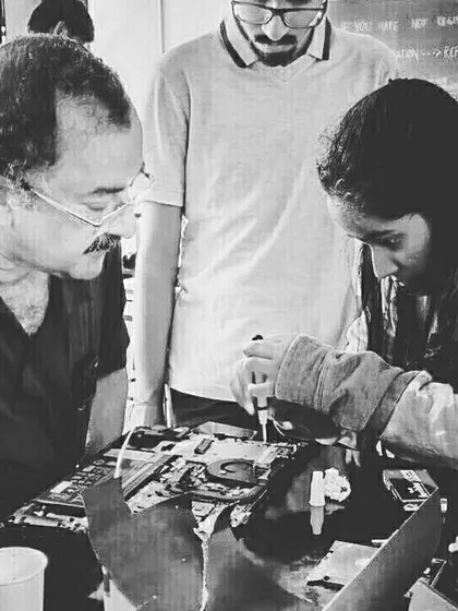 A focused moment between a mentor and a student during a laptop repair session. We believe in personalized guidance to help each child build confidence and master complex tasks like diagnosing and fixing electronic devices.