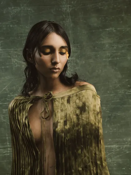 A close-up of the artistic makeup from the "Concrete Woes" editorial. We used gold leaf and earthy tones to create a look that feels both natural and surreal.
