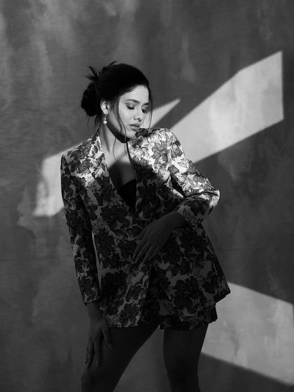 An artistic black and white shot with dramatic lighting. This photo highlights Karunya's modeling skills and the versatility of the look.