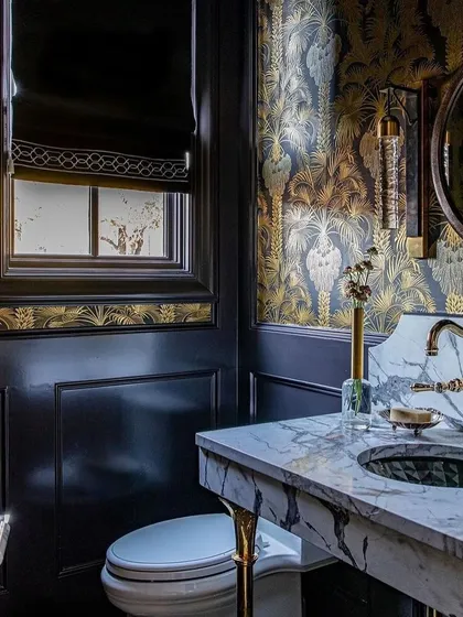 A powder room is given a dose of Hollywood glamour with the Hollywood Palm wallpaper from the Martyn Lawrence Bullard collection. The metallic gold palms against a dark background create an instant classic, deco-inspired look.