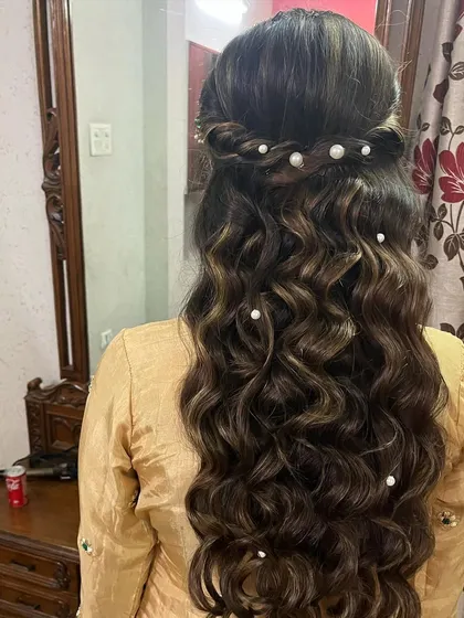 We added delicate pearl pins to these deep waves for a touch of elegance. This is a beautiful way to accessorize an open hairstyle for a formal event.
