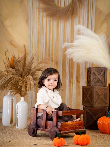 A fun moment in a wooden wagon. This rustic, autumn-toned setup is simple yet full of charm.