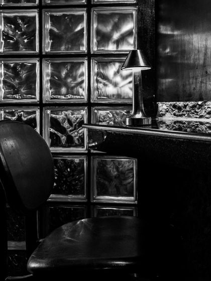 Dive into Lair’s enigmatic beauty, a realm where secrets linger and wonder abounds. The contrast between the smooth bar top and the textured glass blocks is central to our design philosophy.