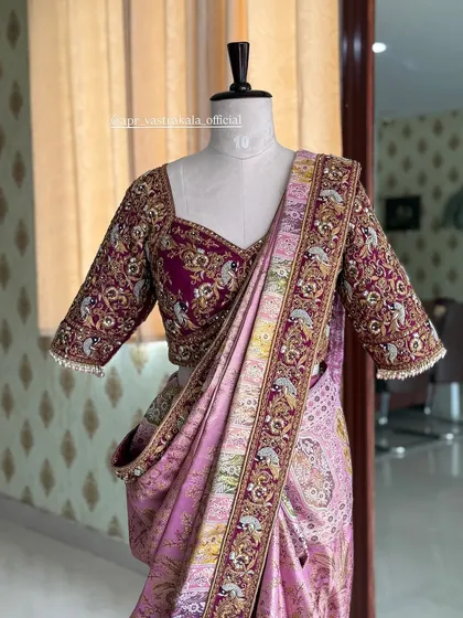 A full-length view of the maroon and lavender bridal ensemble on a mannequin, showing the elegant drape and rich detailing that makes it perfect for a wedding ceremony.