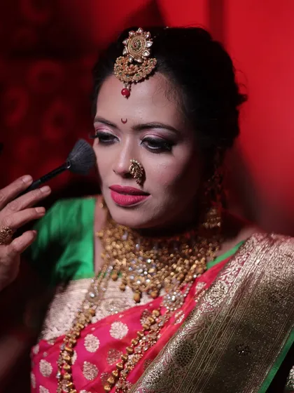 Here, I am demonstrating the correct way to apply finishing powder. This is a crucial step for setting makeup, controlling shine, and ensuring a bride's look stays fresh for hours.