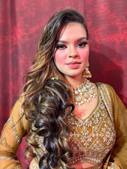 A full view of this stunning 90s-inspired royal glam look. The focus is on dramatic, kohl-rimmed eyes, beautifully highlighted skin, and voluminous hair, perfect for a sangeet or reception.