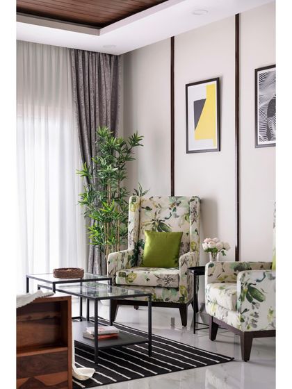In this villa living room, I used floral-patterned wingback chairs to add a touch of classic charm. Paired with a modern black coffee table and simple decor, the space feels both timeless and fresh.