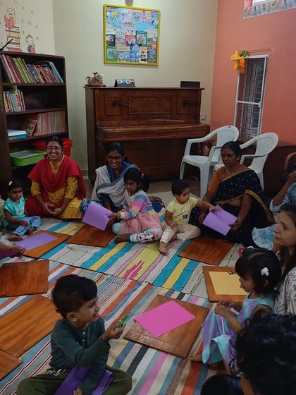 The group works together on their paper crafts, sharing materials and ideas.