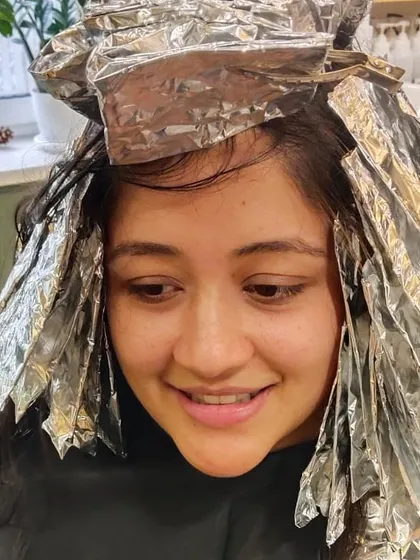 Another angle of the foiling process, showing the careful sectioning required for a professional hair colour service.