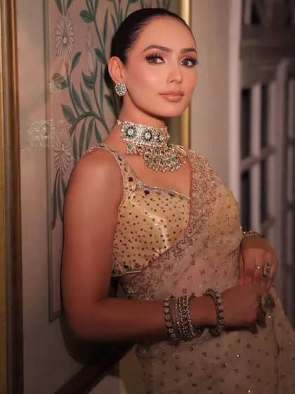 A beautifully styled look in a golden saree. I curated this for a makeup artist's portfolio, pairing the outfit with a statement choker and elegant bangles.
