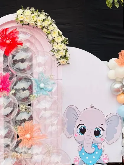 A close-up of the right side of the backdrop, showing the cute baby elephant and the pastel balloon garland. The details make this setup perfect for welcoming a little one.