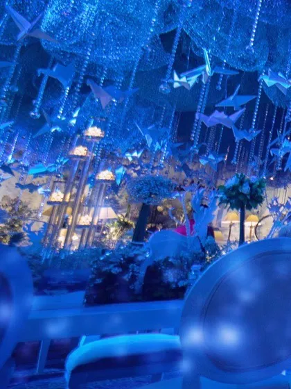A view from a guest's table, looking up at the sky of paper birds. This perspective shows how the immersive decor surrounded guests from every angle.