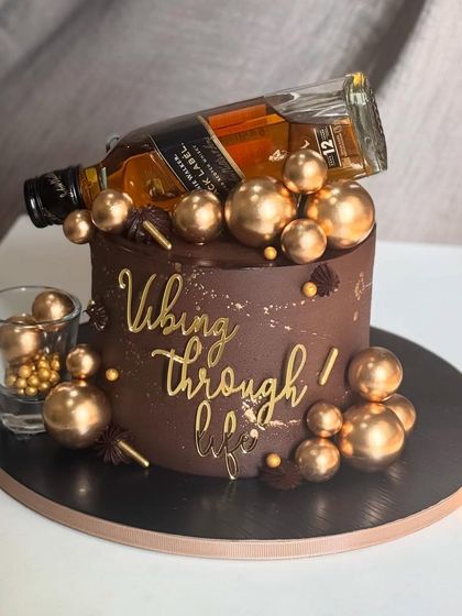 For celebrations that don't need a reason, just a bold mood. This rich chocolate cake is loaded with golden glam and whiskey vibes, making it the perfect centerpiece for a stylish get-together.
