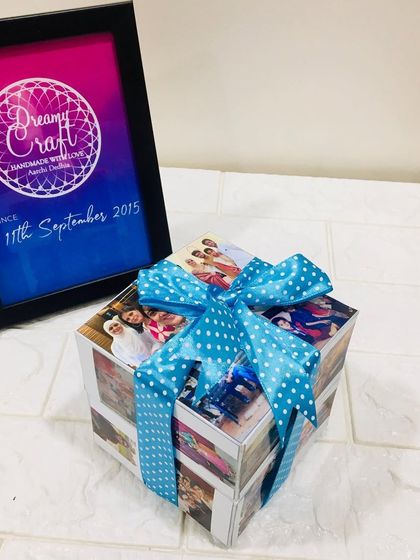 This is a photo cube I made, which is another fun, interactive way to display memories. It's covered with 48 photos and tied with a bow.