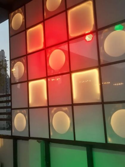 A custom-built, color-changing light panel that adds a dynamic and modern feature to the restaurant's decor.