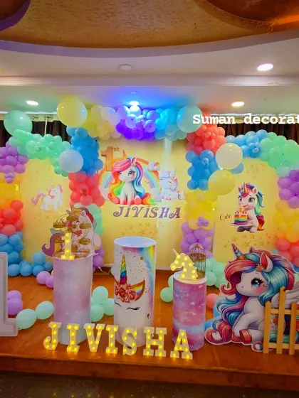 A complete view of the unicorn stage decoration, including the small fence prop and themed pedestals, creating a perfect photo opportunity.