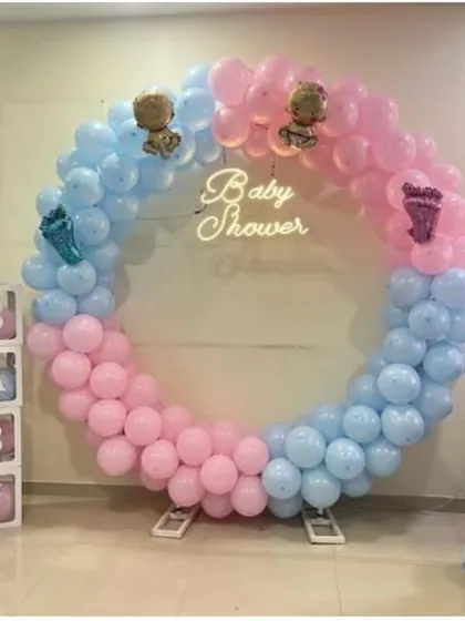 Celebrating a baby shower with a classic 'He or She' theme. We used a full circle balloon frame in pink and blue, with a 'Baby Shower' neon sign at the center. The setup is completed with 'It's a Boy' and 'It's a Girl' balloon columns and transparent 'BABY' display boxes.