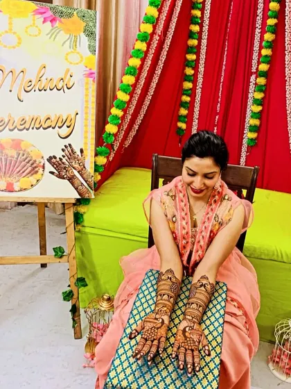 A bride posing with her completed mehndi at her home ceremony. I provide doorstep service to make your experience as comfortable and special as possible.