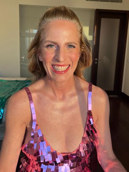 A smiling shot that shows how radiant and happy my client looks. The makeup is designed to enhance her features and bring out her natural glow.