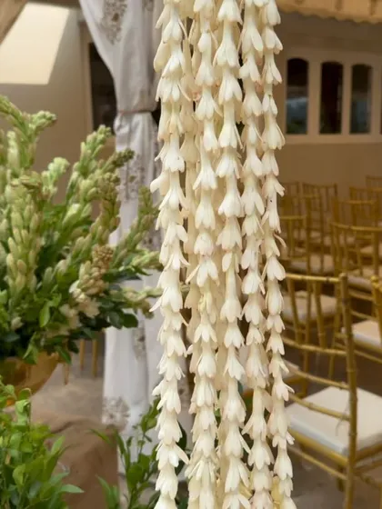 A beautiful tuberose garland, showcasing the delicate texture and traditional floral work that is central to heritage decor.