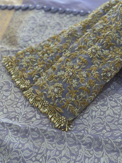 The sleeves of the lavender blouse, with all-over floral work.