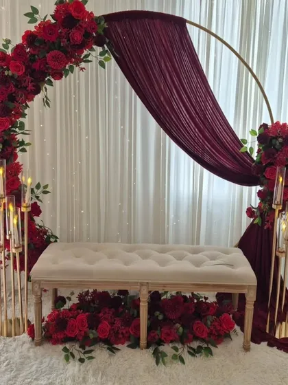 This elegant stage is perfect for a ring ceremony or sagan. We created a modern look with a deep red floral arch, matching drapes, and elegant candelabras for a sophisticated and romantic pre-wedding function.