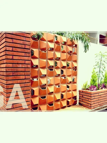 This terracotta jali wall is more than a decorative feature. It's a climate-control screen that allows for natural airflow while providing shade, an example of how we use traditional techniques in modern residential architecture to create energy-efficient homes.