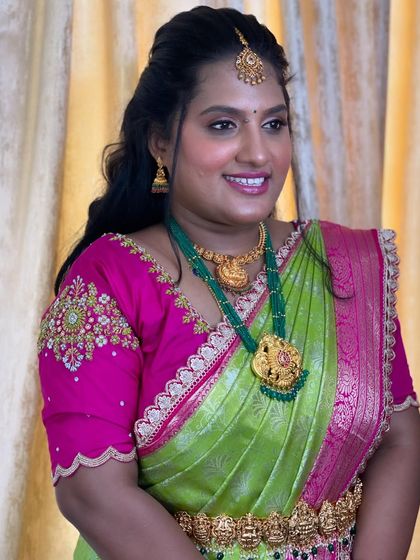 Deepika looking stunning for her sister's engagement. Her vibrant saree is paired with beautiful green beaded jewelry and a fresh, glowing makeup look.