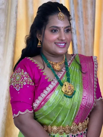 Deepika looking stunning for her sister's engagement. Her vibrant saree is paired with beautiful green beaded jewelry and a fresh, glowing makeup look.