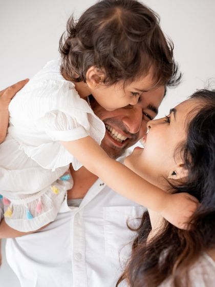 A moment of pure joy and laughter between parents and their child.