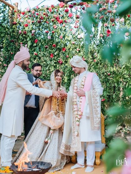 A candid moment from an intimate wedding ceremony, with family members participating in the rituals.