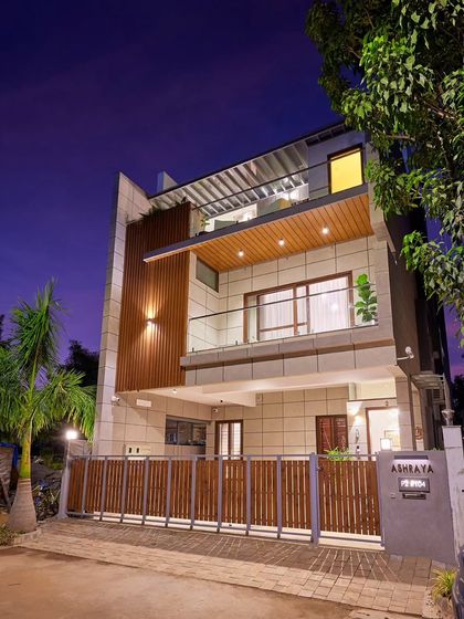 A duplicate image of the Odion Woods villa at dusk, showing the facade lighting.
