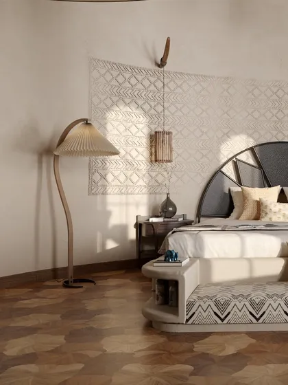 This close-up highlights the rich textures within a guest room. A patterned wall hanging, a unique floor lamp with a pleated shade, and a custom-designed bed with an integrated bench all contribute to a layered and sophisticated interior design.