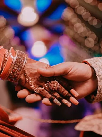 A simple yet powerful shot of a couple holding hands during their ceremony. This image symbolizes the beginning of a new journey together and is an example of how we focus on the small, meaningful details that tell the larger story of your wedding day.