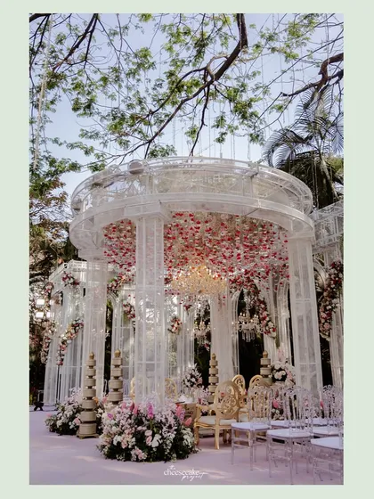 A closer look at the intricate and elegant mandap, with its crystal-like pillars and stunning floral arrangements.