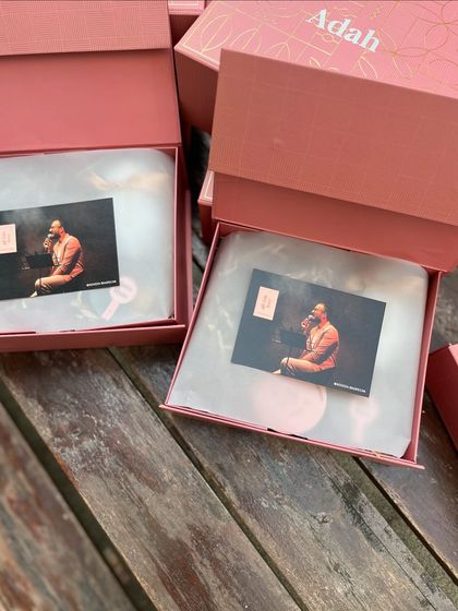 The unboxing experience begins. Here you see the personalized boxes for a book launch, with a photo card of the author placed on top, immediately connecting the recipient to the story.