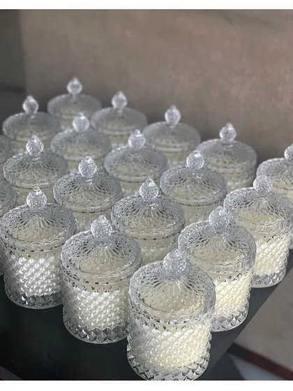 A batch of our crystal jar candles lined up, ready for a wedding. Their sparkling design catches the light beautifully, making them a decorative piece as well as a scented gift.