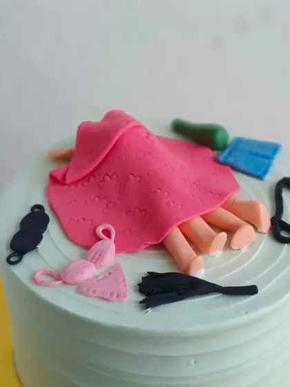 A close-up on the funny fondant details of the bachelorette cake.