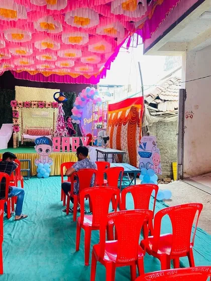 A view of the baby shower seating area, showing the pandal setup and the stage in the background.