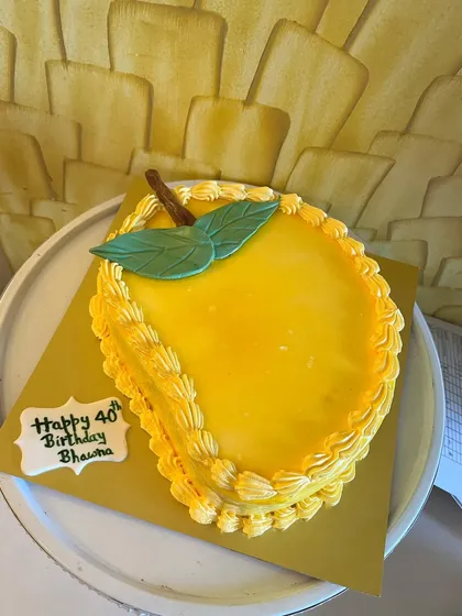 A fun, mango-shaped cake for a mango lover's 40th birthday. While it looks like a mango on the outside, it holds a surprise red velvet cake inside, showing my creative approach to custom designs.