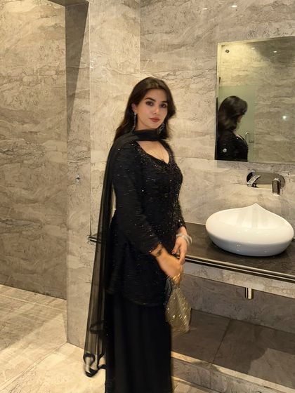 Another angle of the black sequined outfit, showing how it looks from the side. Providing multiple angles helps customers better visualize the fit and flow of the garment.