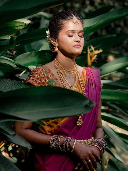 Sushma's bridal glow, perfected. This shot amidst nature highlights the flawless HD makeup that enhances her natural beauty for her Muhuratam.