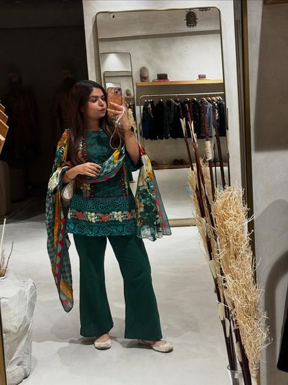 A mirror selfie in a beautiful green printed salwar suit. This is a great example of everyday ethnic wear that is both stylish and comfortable.