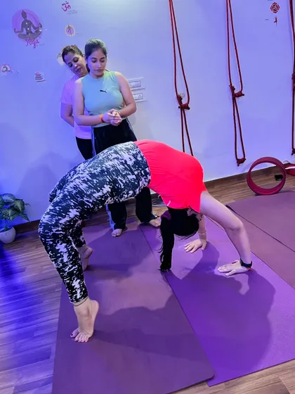 An advanced student holding a perfect wheel pose, demonstrating amazing flexibility and strength.