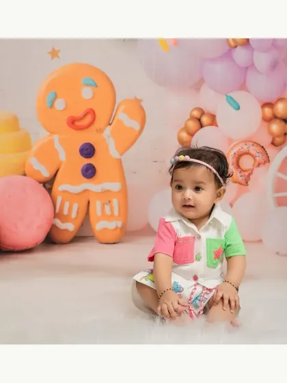Sweet as a gingerbread cookie! This six-month milestone shoot features a colorful and fun Candyland theme with a giant gingerbread man.